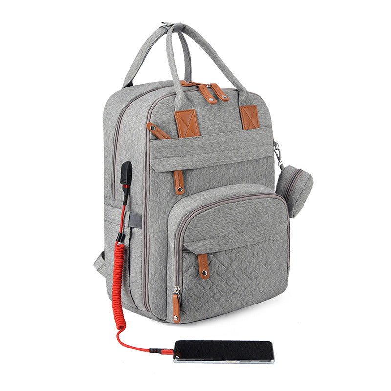 Bolsa multifuncional para cochecito con carga USB y compartimentos separados para ropa seca y húmeda.