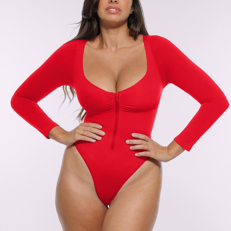 Mono de manga larga con media cremallera de color liso para mujer