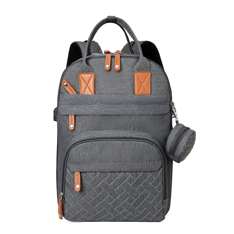 Bolsa multifuncional para cochecito con carga USB y compartimentos separados para ropa seca y húmeda.